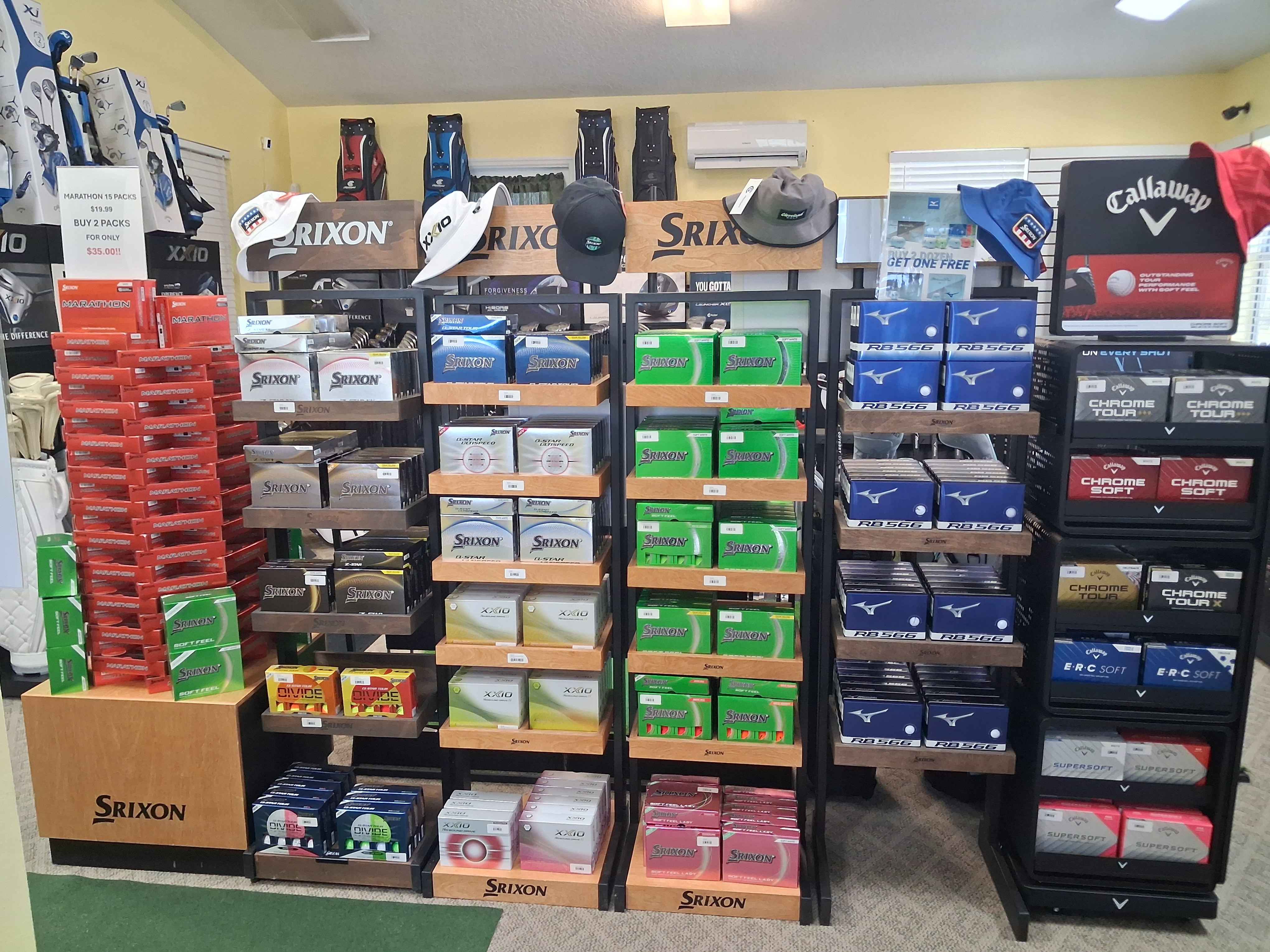 Golf ball selection at Oxford Golf Academy pro shop including Srixon, Mizuno, and Callaway
